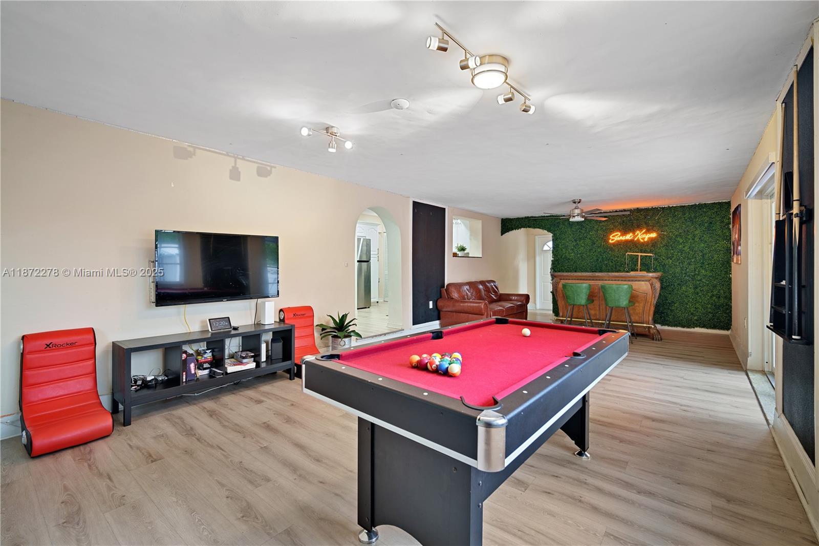 951 Northwest 148th Street Miami, FL 33168 - Photo 15 of 34 a living room with a flat screen tv and pool table