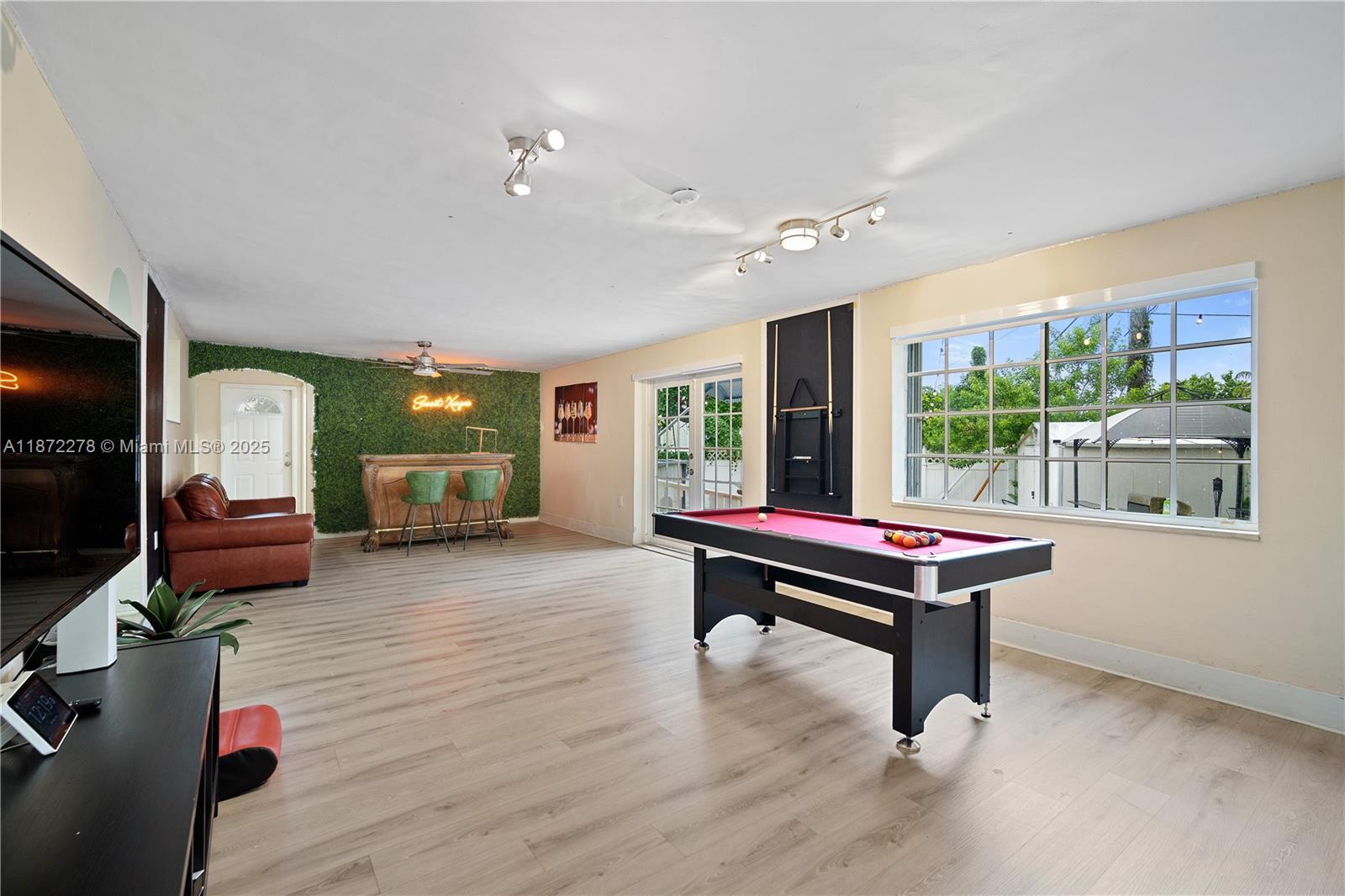 951 Northwest 148th Street Miami, FL 33168 - Photo 16 of 34 a room with furniture pool table wooden floor and windows