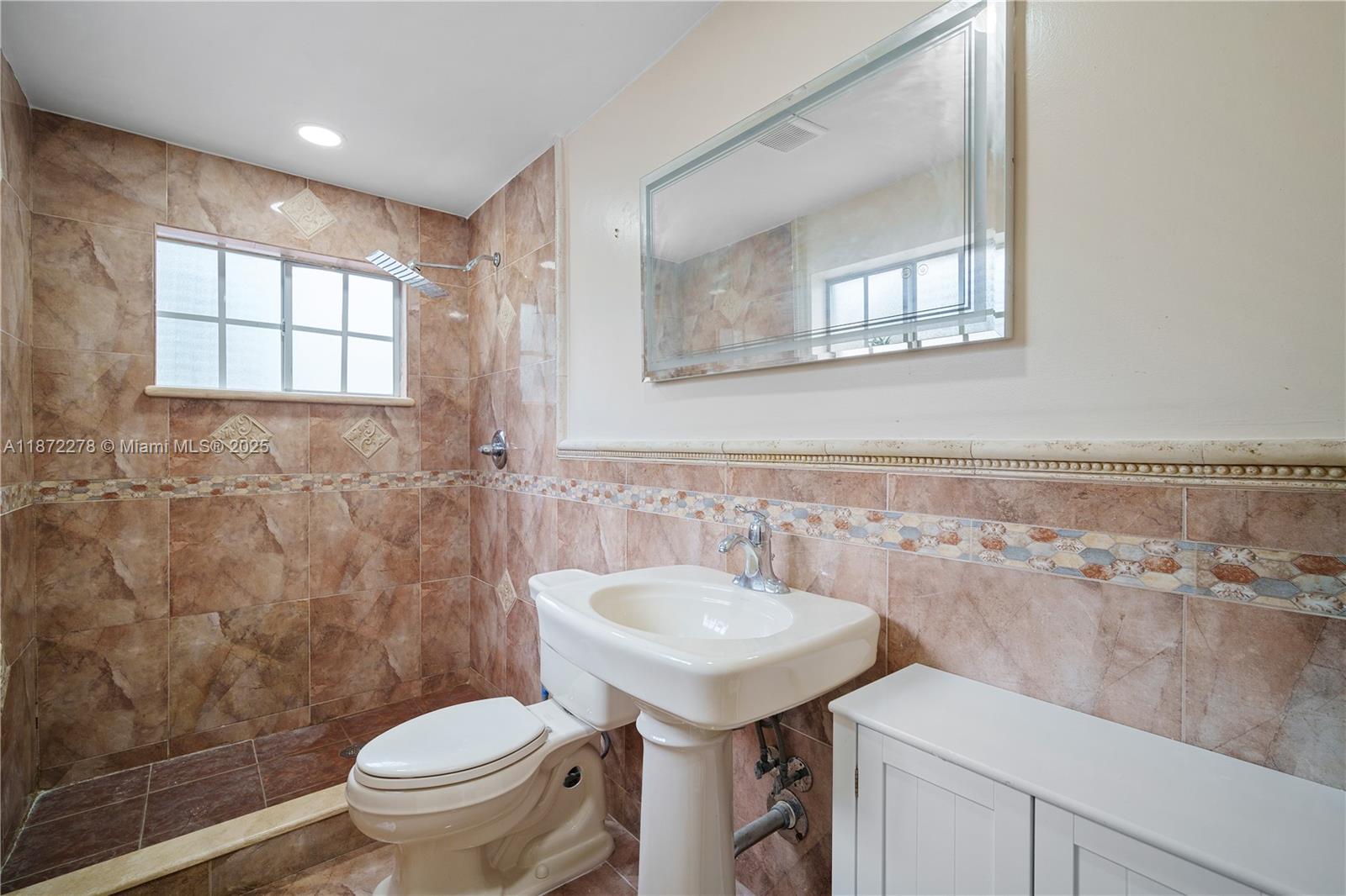 951 Northwest 148th Street Miami, FL 33168 - Photo 18 of 34 a bathroom with a sink toilet and a mirror