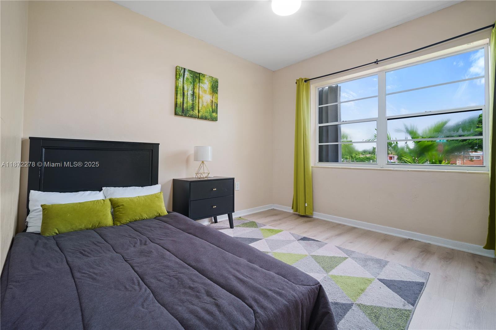 951 Northwest 148th Street Miami, FL 33168 - Photo 20 of 34 a bedroom with a bed and window