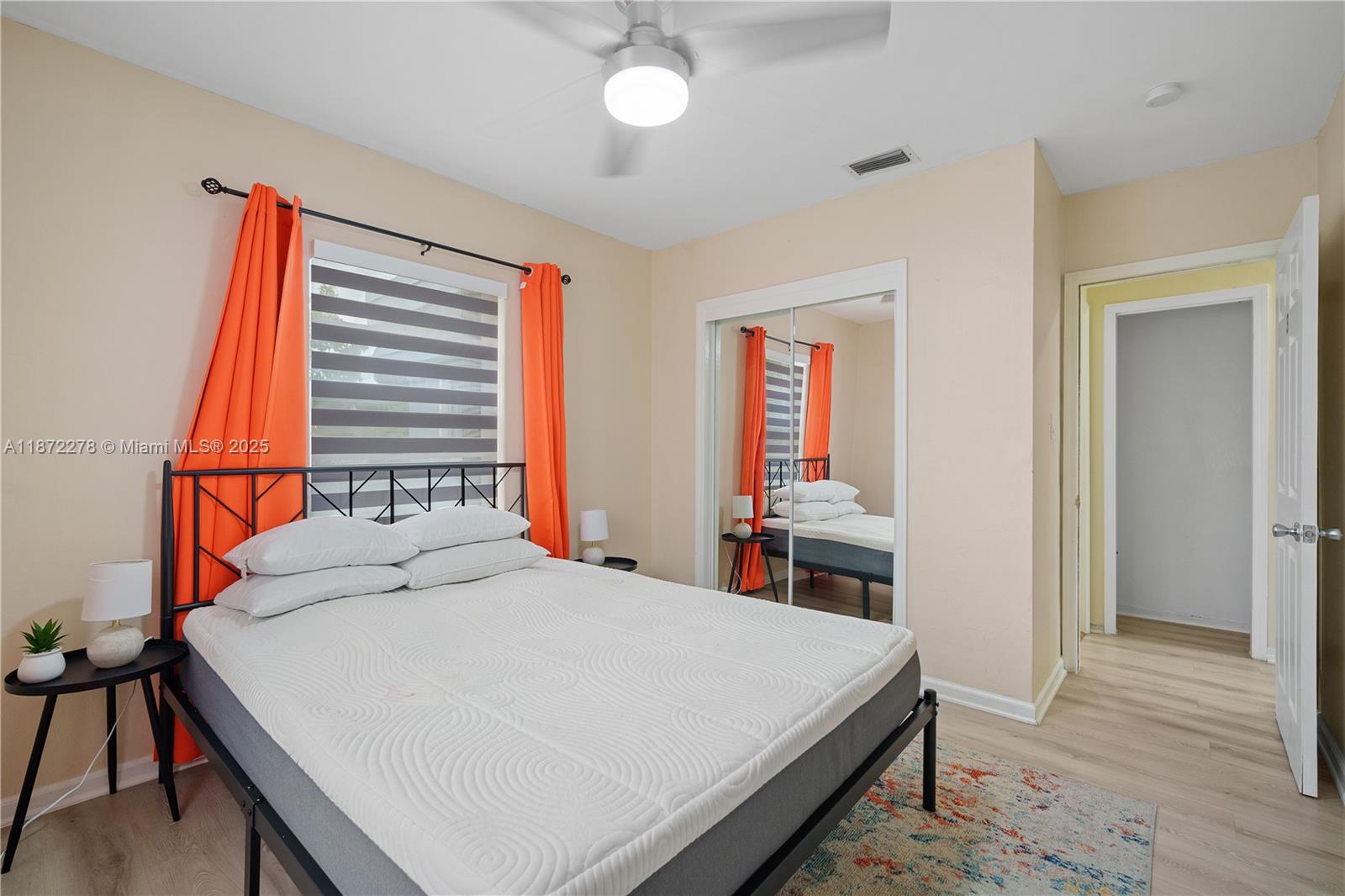 951 Northwest 148th Street Miami, FL 33168 - Photo 26 of 34 a bedroom with a bed and a chandelier