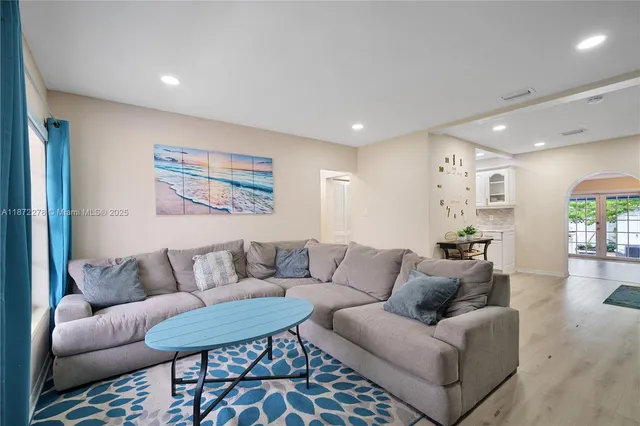 a living room with furniture and wooden floor
