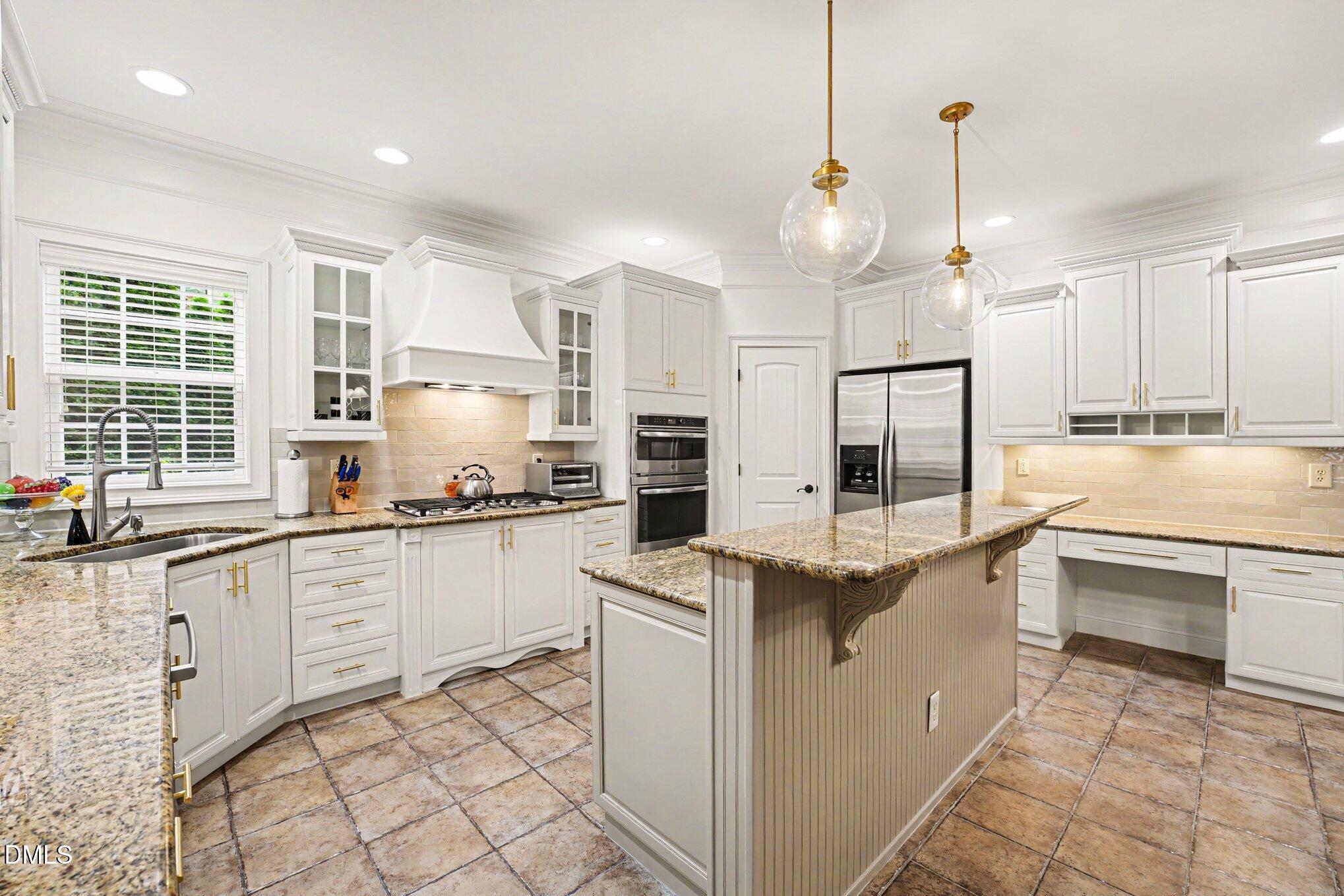 1729 Frenchwood Drive Raleigh, NC 27612 - Photo 6 of 46 a kitchen with white cabinets appliances and a window