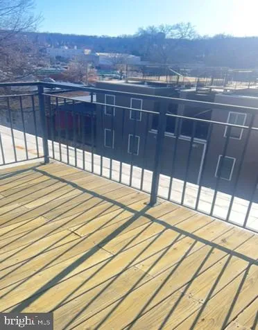 a view of a balcony with wooden floor and city view