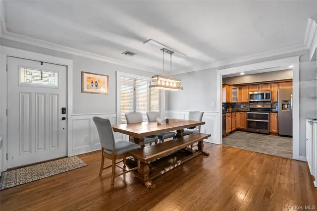 a living room with furniture a table and kitchen view