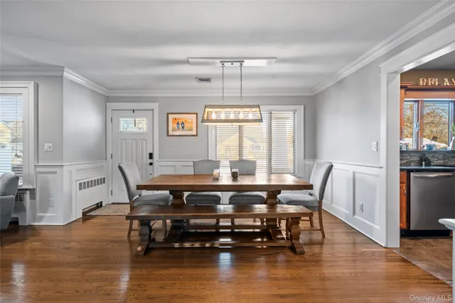 a view of a dining room with furniture window and wooden floor