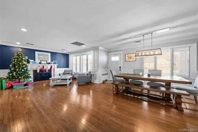 a living room with furniture toys and a wooden floor