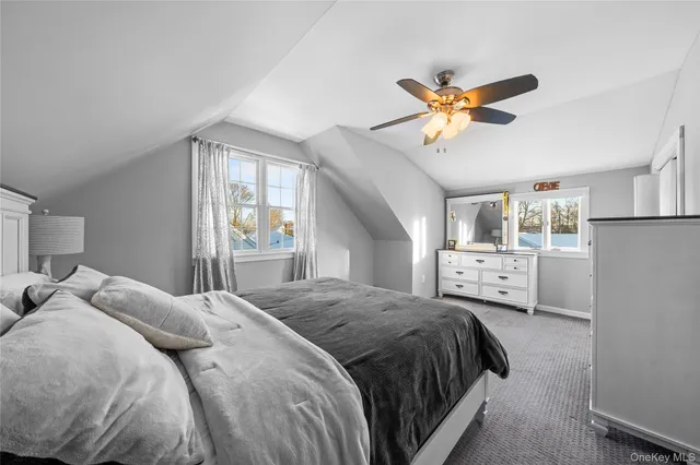 a bedroom with a bed and a ceiling fan