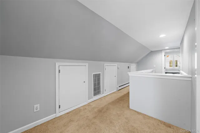 a view of a kitchen with refrigerator and white cabinets