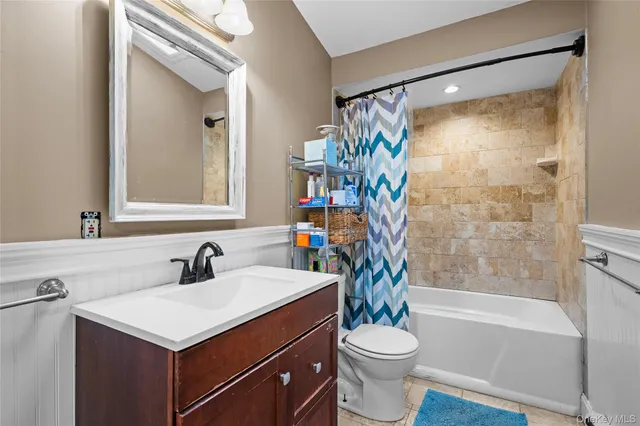 a view of a patio with table and chairs and wooden fence
