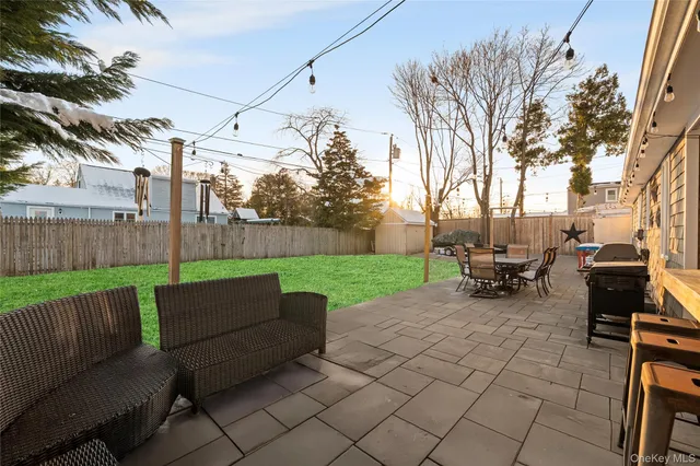 a view of a backyard with sitting area