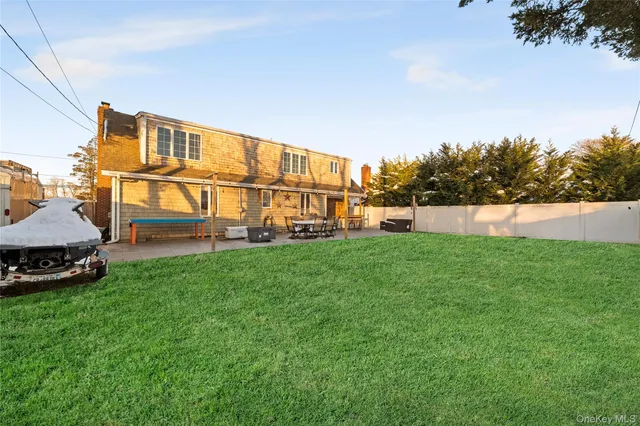 a view of a house with a yard and sitting area
