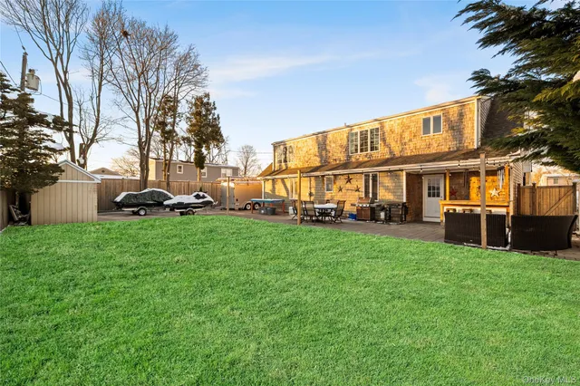 a patio with glass top table and chairs
