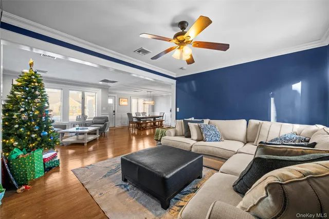 a living room with furniture and flowers