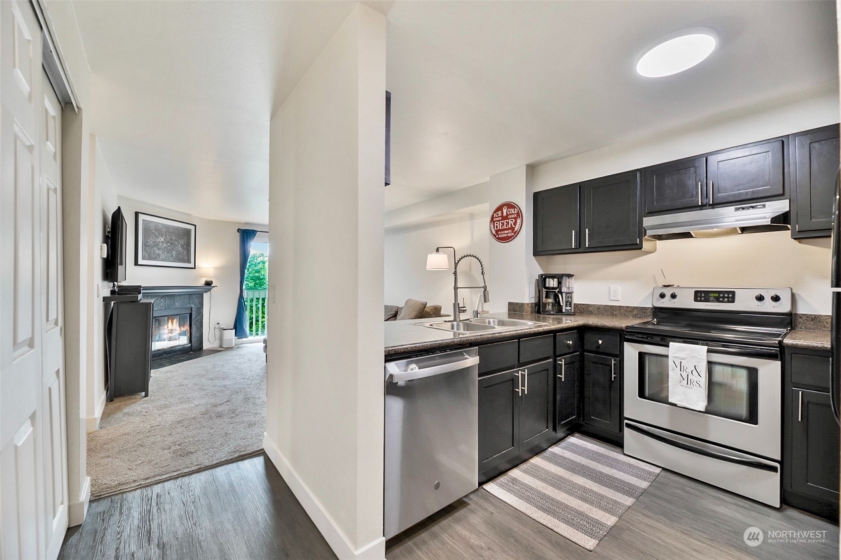 16409 Currie Road Southeast, Unit 305 Monroe, WA 98272 - Photo 1 of 23 a kitchen with stainless steel appliances granite countertop a stove sink and cabinets