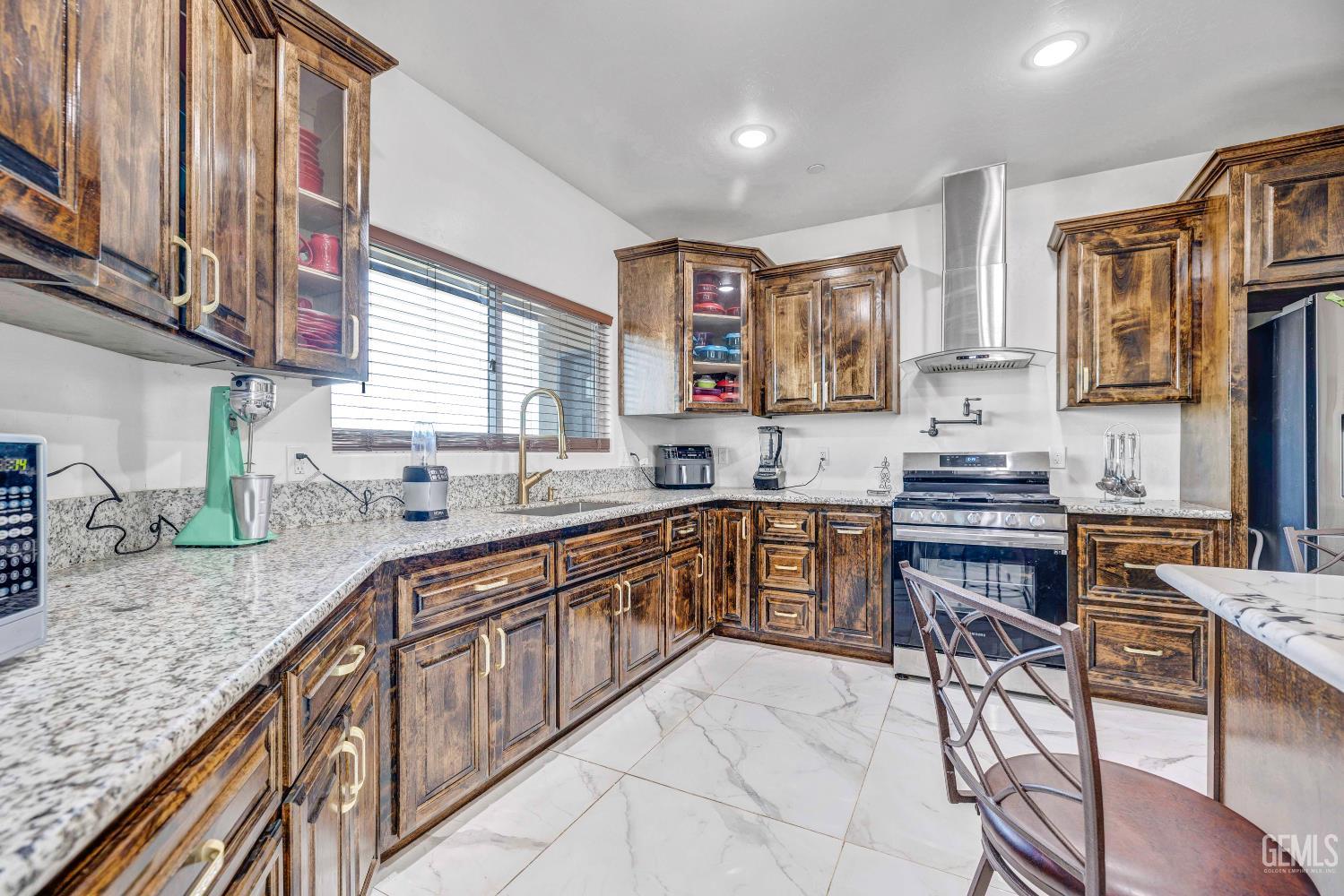 Undisclosed Address Taft, CA 93268 - Photo 12 of 43 a large kitchen with granite countertop a sink and cabinets