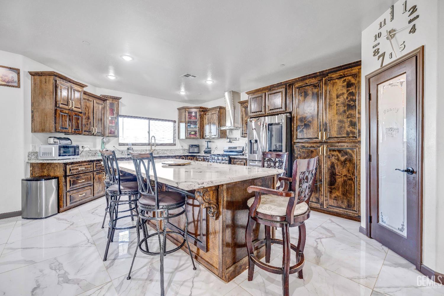 Undisclosed Address Taft, CA 93268 - Photo 16 of 43 a dining area with stainless steel appliances kitchen island granite countertop a refrigerator and cabinets