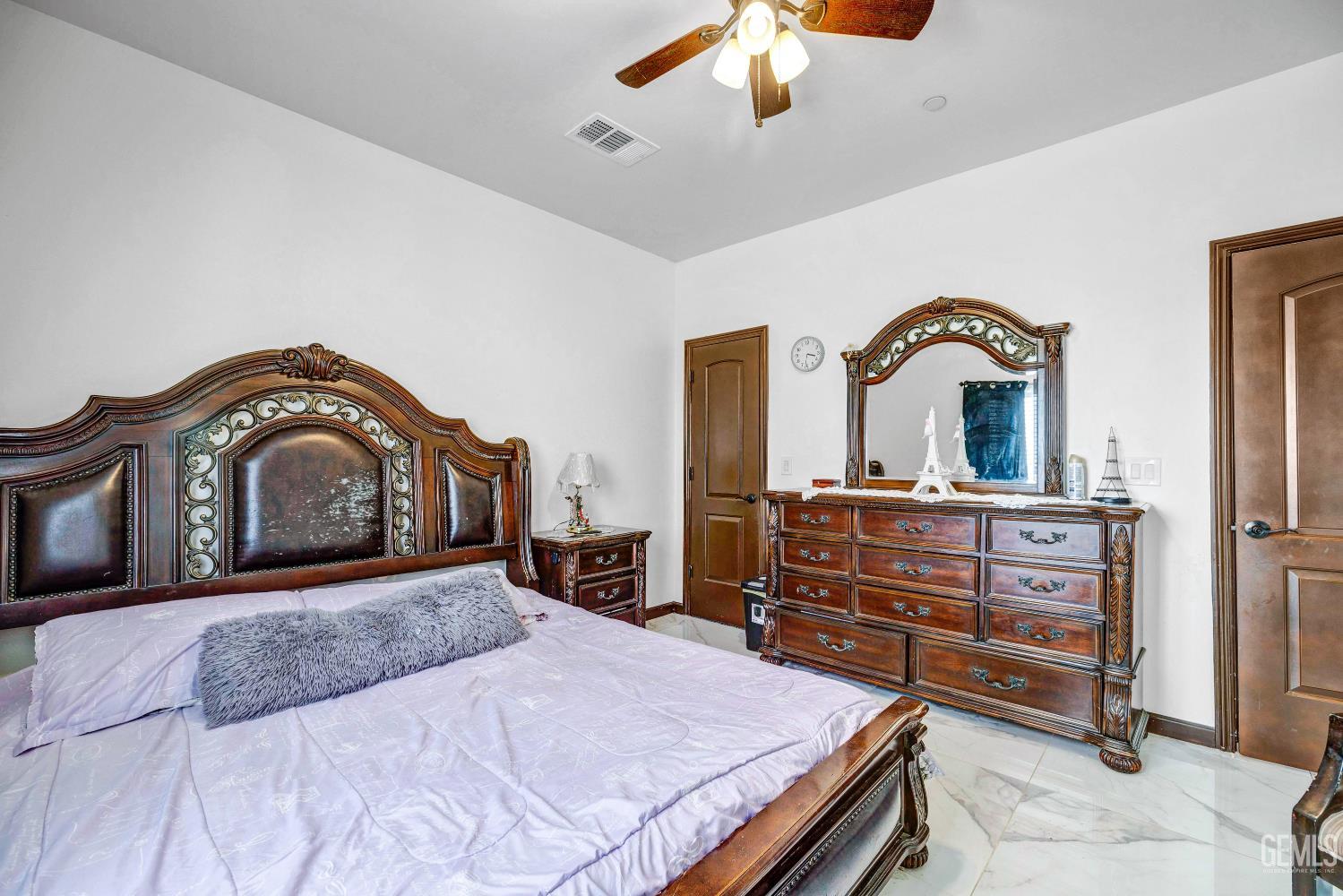 Undisclosed Address Taft, CA 93268 - Photo 20 of 43 a bedroom with a bed and a dresser