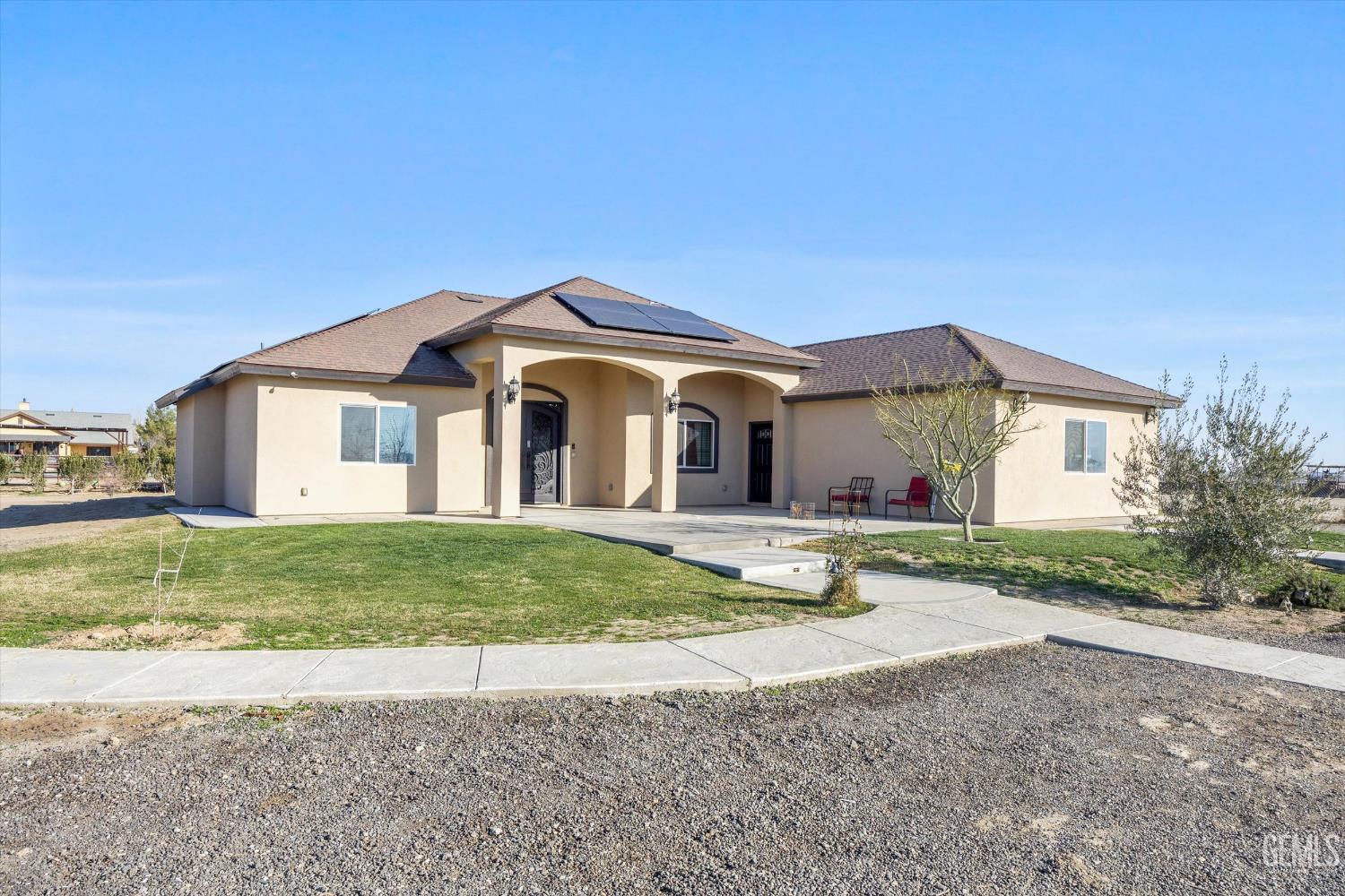 Undisclosed Address Taft, CA 93268 - Photo 2 of 43 a front view of a house with a yard and garage