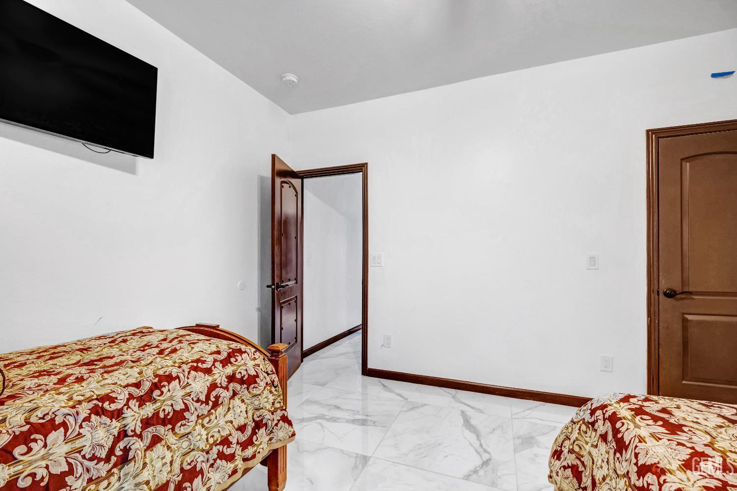 Undisclosed Address Taft, CA 93268 - Photo 22 of 43 a bedroom with a bed and a flat screen tv