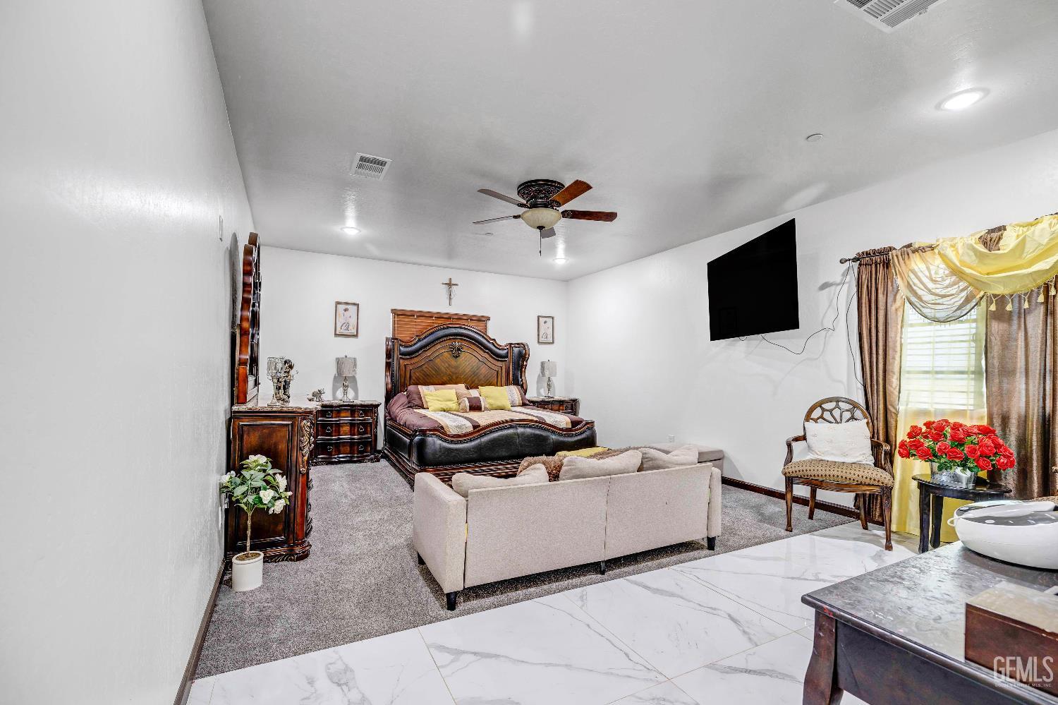 Undisclosed Address Taft, CA 93268 - Photo 23 of 43 a living room with furniture and a flat screen tv