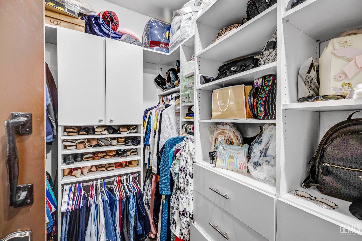 Undisclosed Address Taft, CA 93268 - Photo 29 of 43 a view of walk in closet with clothes and shoes