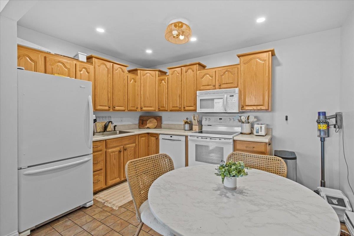 1351 Virginia Cape May, NJ 08204 - Photo 15 of 29 a kitchen with granite countertop white cabinets a refrigerator a stove a dining table and chairs