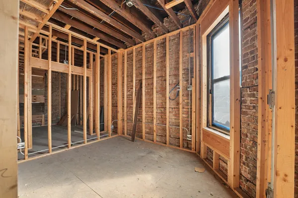 a view of a room with wooden floor and windows