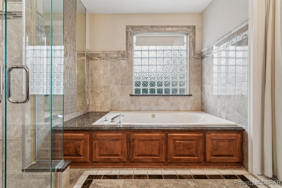 1318 Showalter Road Yorktown, VA 23692 - Photo 24 of 47 Bathroom featuring shower with separate bathtub and tile walls