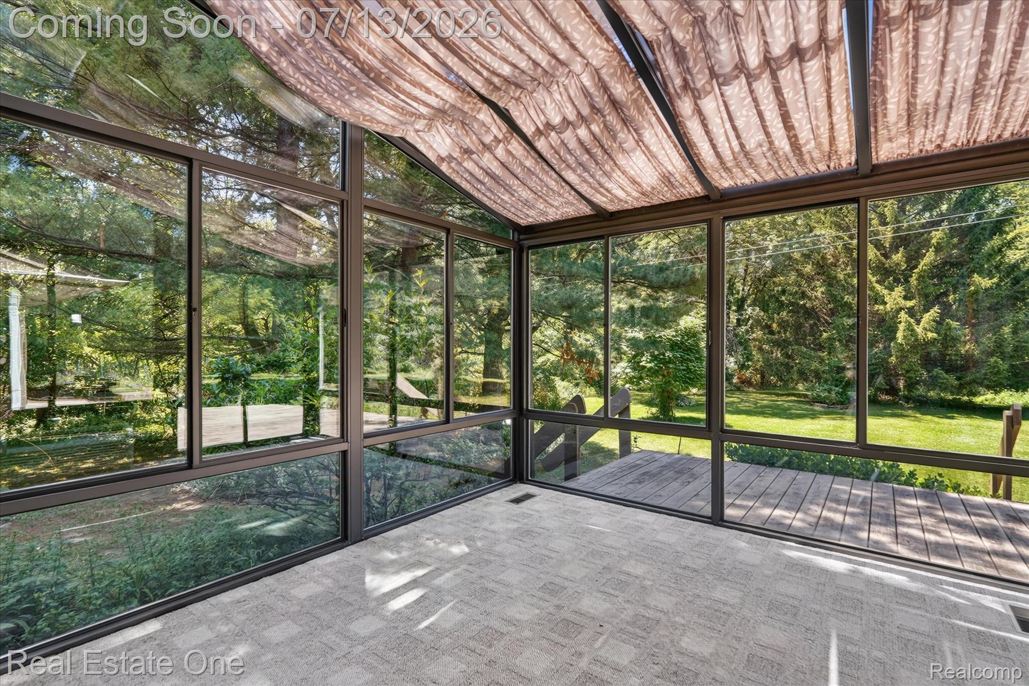 6039 Fish Lake Road Holly, MI 48442 - Photo 9 of 70 Sunroom featuring full-height glass panels, a fabric-covered sloped ceiling, and direct access to an exterior wood deck
