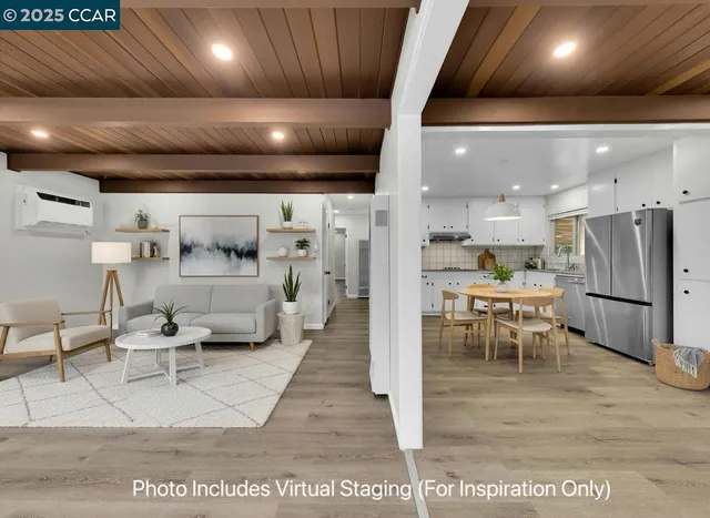 a living room with lots of furniture and kitchen view