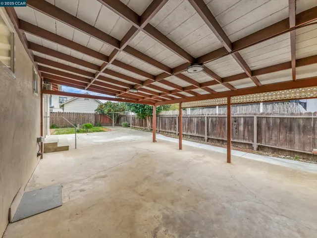 a backyard of a house with table and chairs