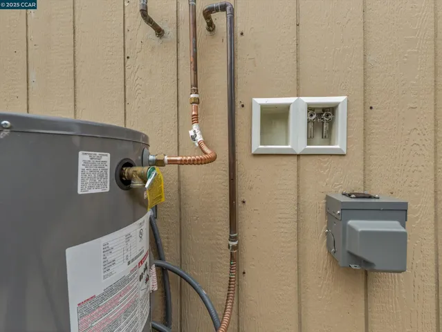 a large white kitchen with stainless steel appliances granite countertop a stove a sink and a refrigerator