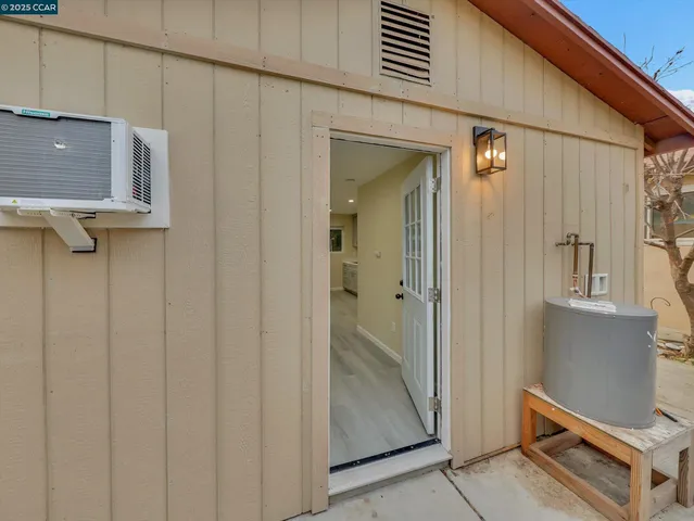 a kitchen with white cabinets and sink