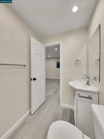 a backyard of a house with plants and wooden fence