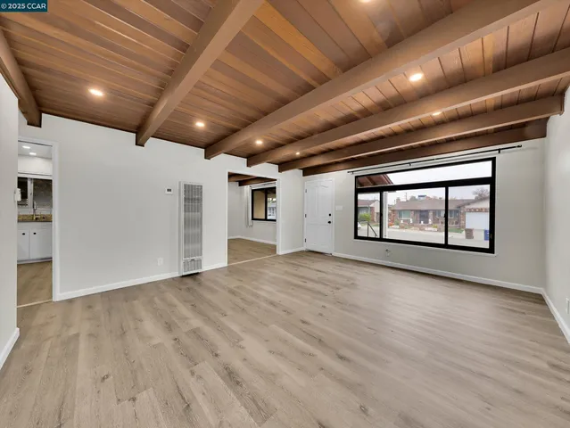 a view of large hall with a chair and a refrigerator