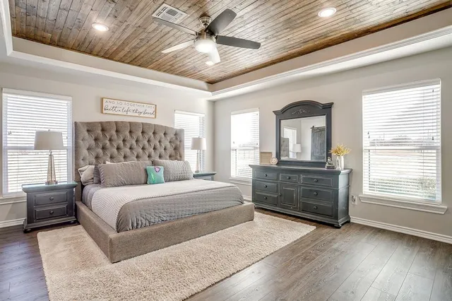 a bedroom with a large bed and a window