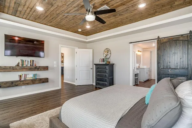 a bed room with a bed window and a television