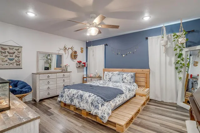 a bedroom with a bed and a chandelier