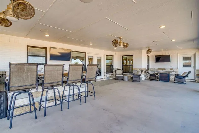 a view of a livingroom with furniture and a window