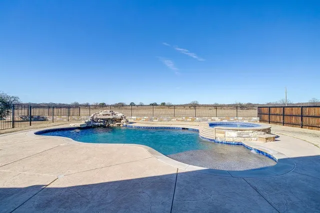 swimming pool view with a seating space