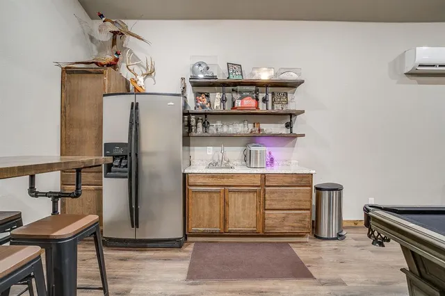 a kitchen with stainless steel appliances granite countertop a refrigerator and a stove top oven