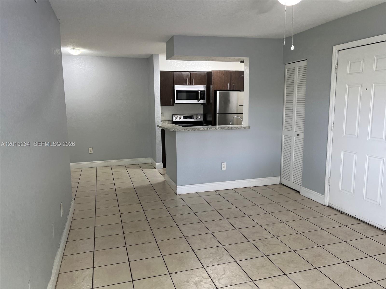 1237 Southwest 46th Avenue, Unit 801 Pompano Beach, FL 33069 - Photo 6 of 8 a view of a livingroom with a couch