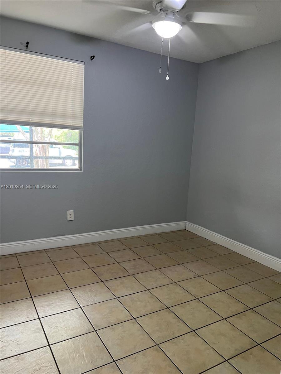 1237 Southwest 46th Avenue, Unit 801 Pompano Beach, FL 33069 - Photo 8 of 8 an empty room with a window
