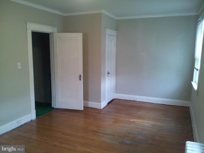 624 Stamford Road Baltimore, MD 21229 - Photo 11 of 21 an empty room with wooden floor and windows