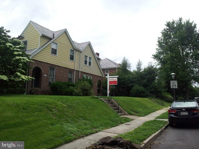 624 Stamford Road Baltimore, MD 21229 - Photo 20 of 21 a front view of a house with a garden and yard