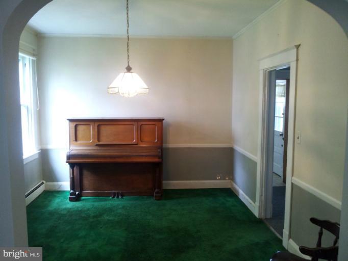 624 Stamford Road Baltimore, MD 21229 - Photo 7 of 21 a living room with a table chairs and a fireplace