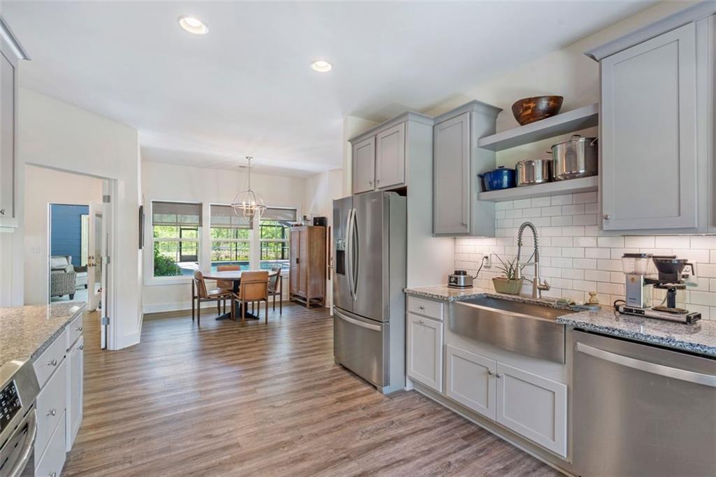 225 Hamrick Road Bremen, GA 30110 - Photo 15 of 61 a kitchen with stainless steel appliances granite countertop a refrigerator a sink dishwasher a stove and white cabinets with wooden floor