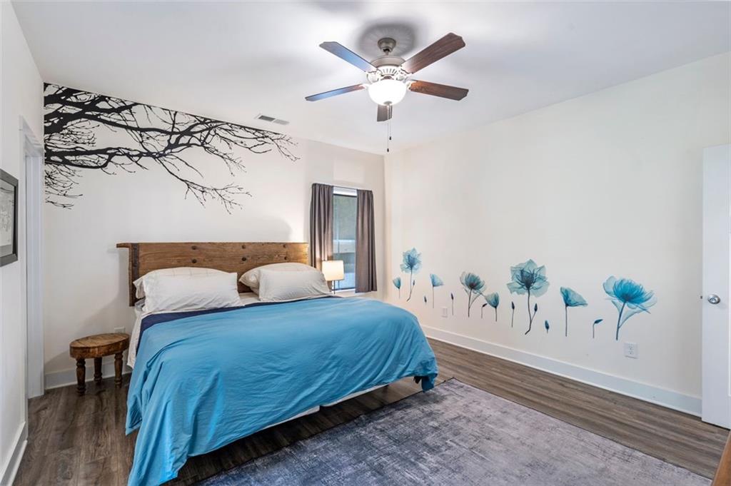 225 Hamrick Road Bremen, GA 30110 - Photo 18 of 61 a bedroom with a large bed and a chandelier