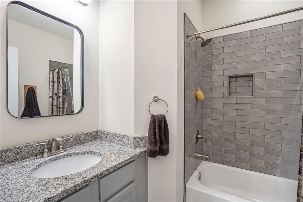 225 Hamrick Road Bremen, GA 30110 - Photo 25 of 61 a bathroom with a granite countertop sink a mirror and shower